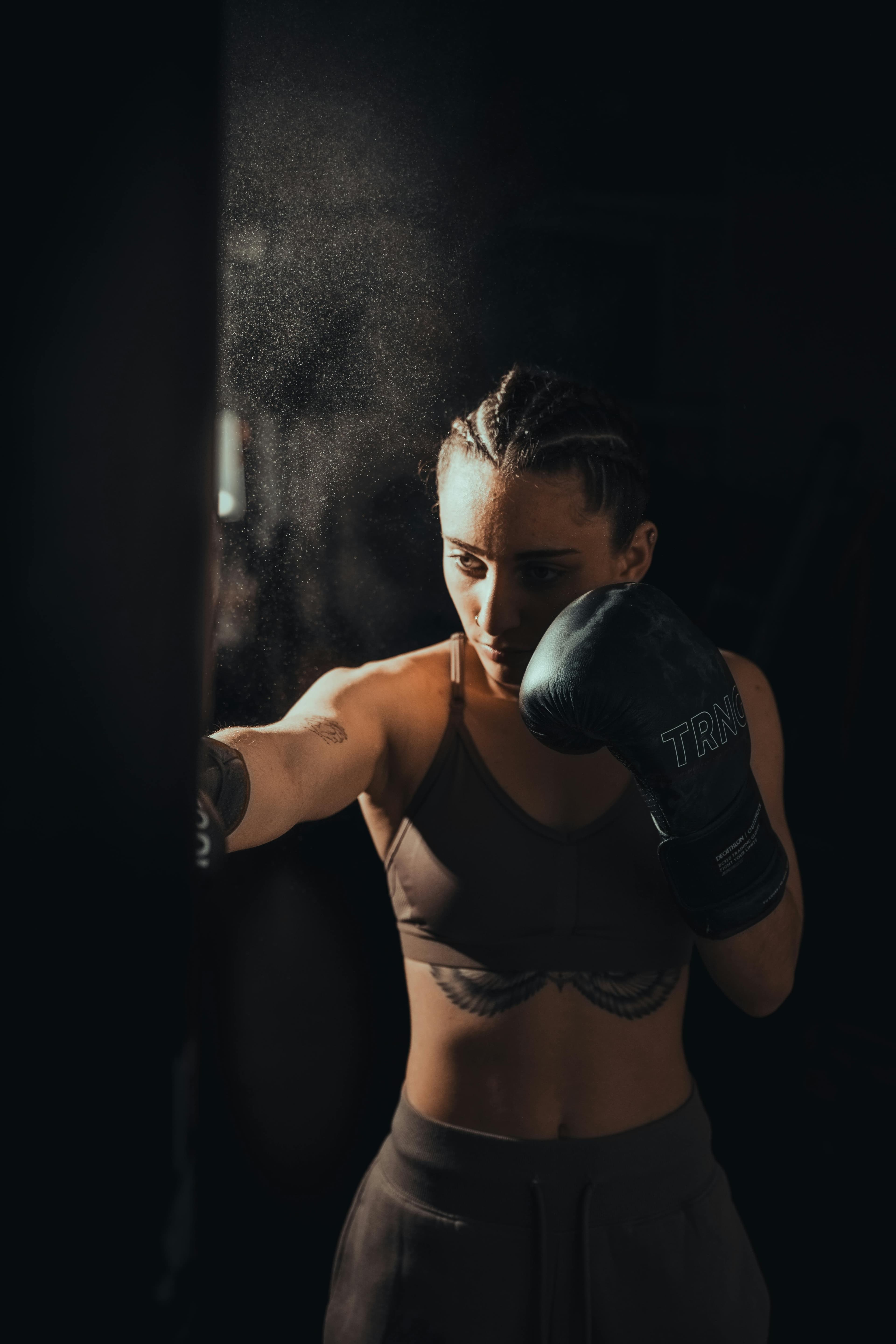 Athletic woman training with dumbbells in a gym